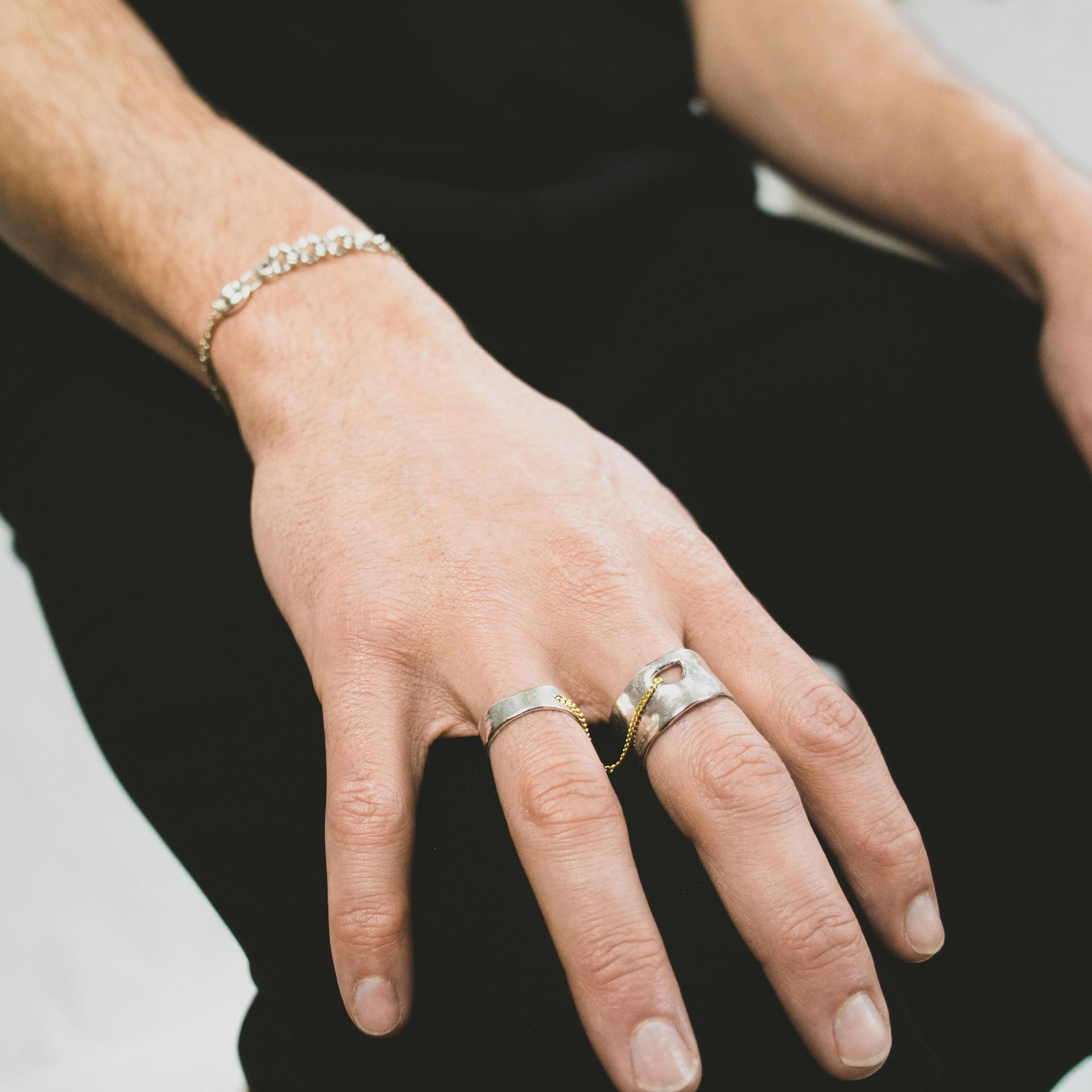 Kara ring composed of two sterling silver bands linked by a 18k gold thin curb chain