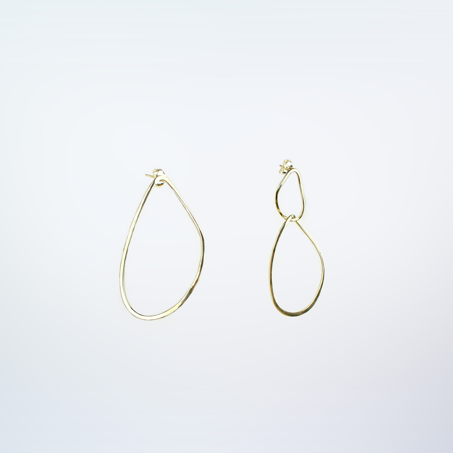 pair of Boroboro long gold plated earrings with asymmetrical shapes.