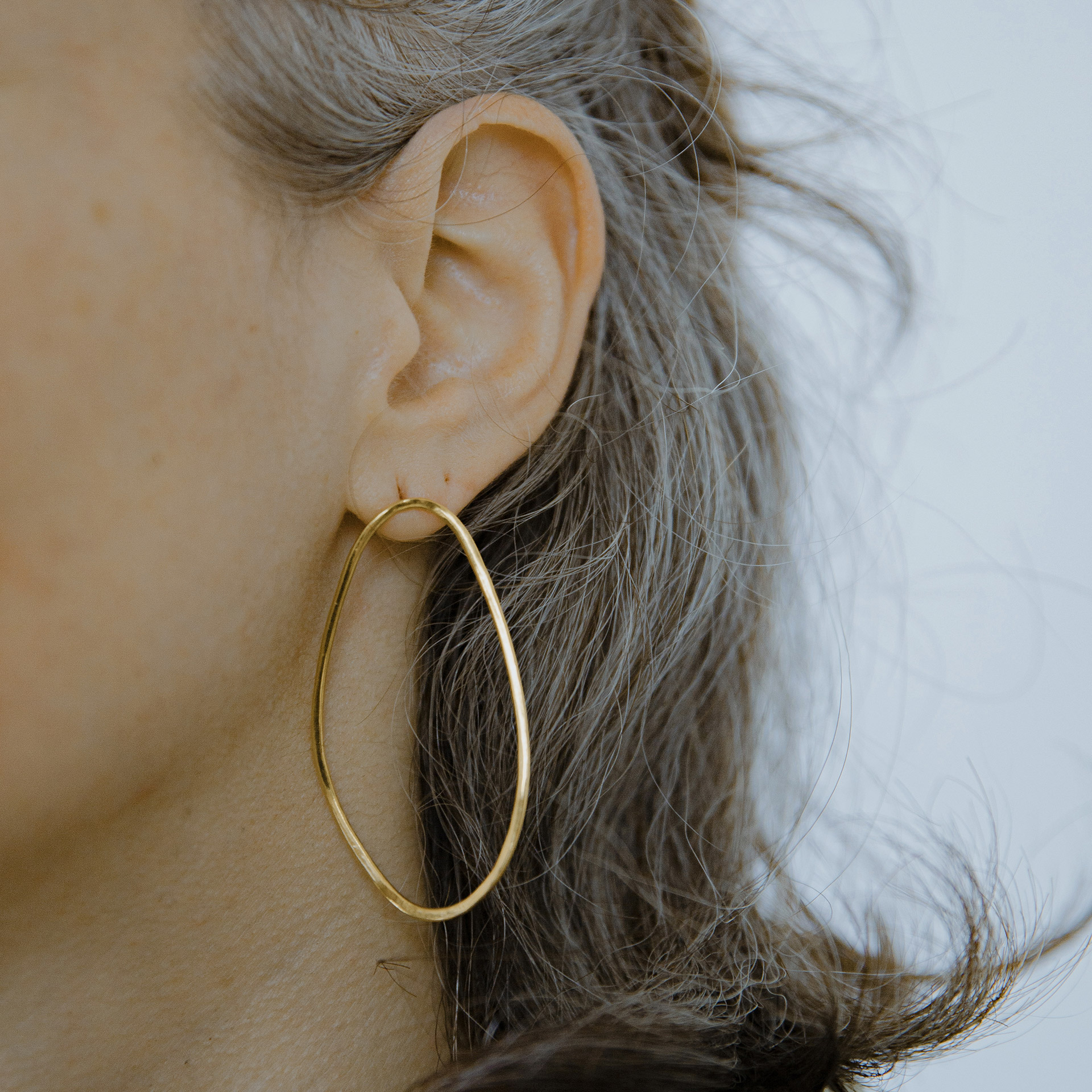 pair of Boroboro long gold plated silver earrings with asymmetrical shapes.