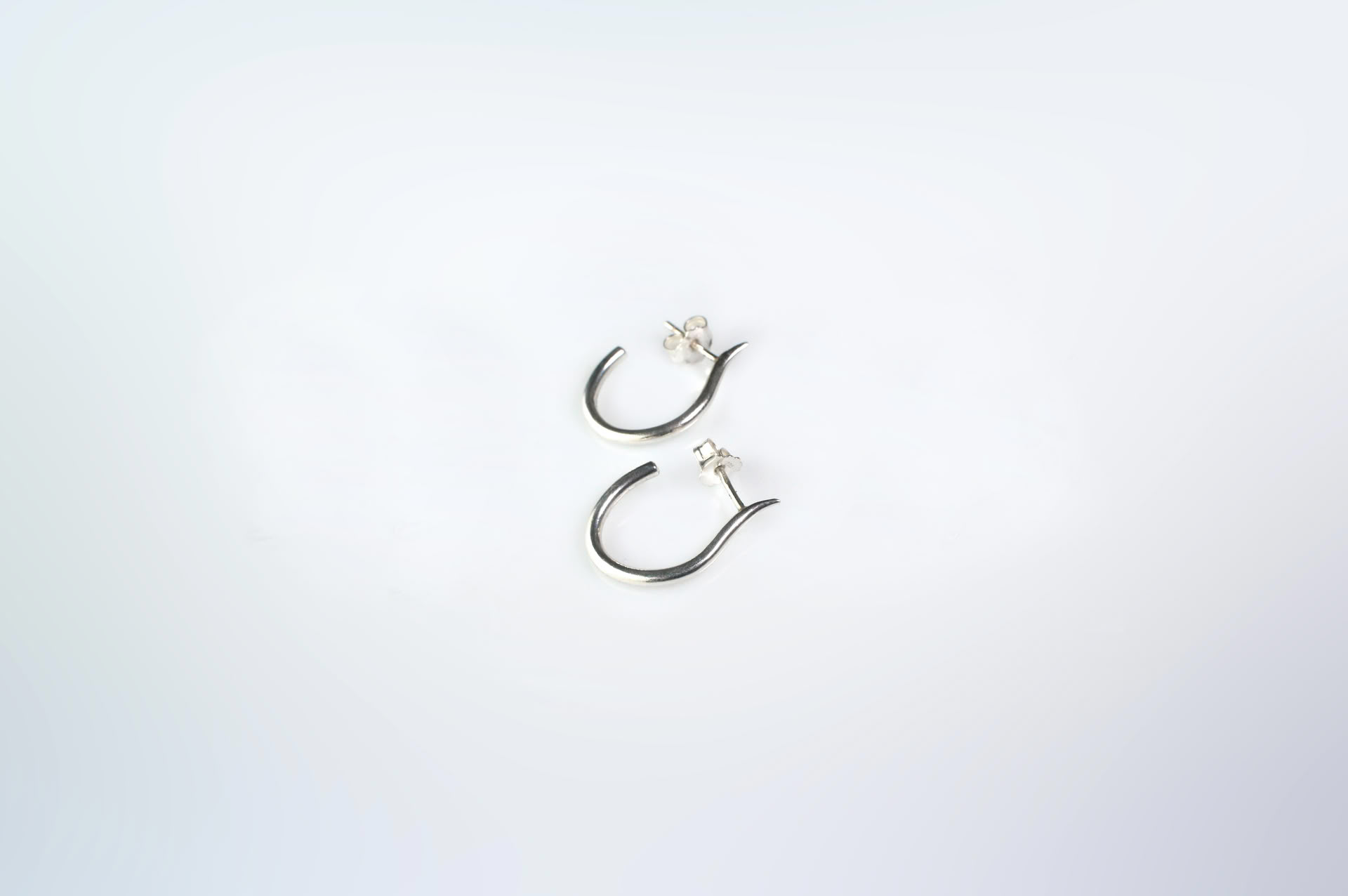 Mugura minimalist silver hoops.