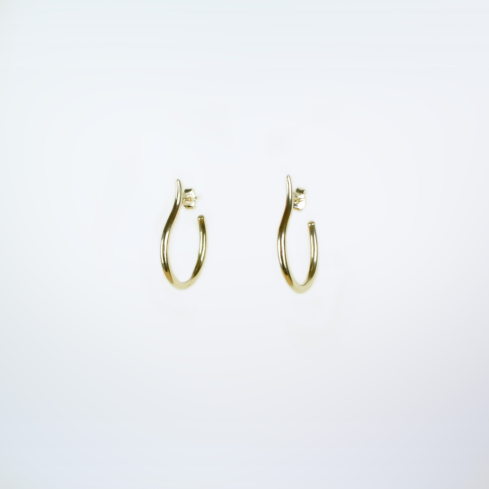 Mugura minimalist gold plated silver hoops.