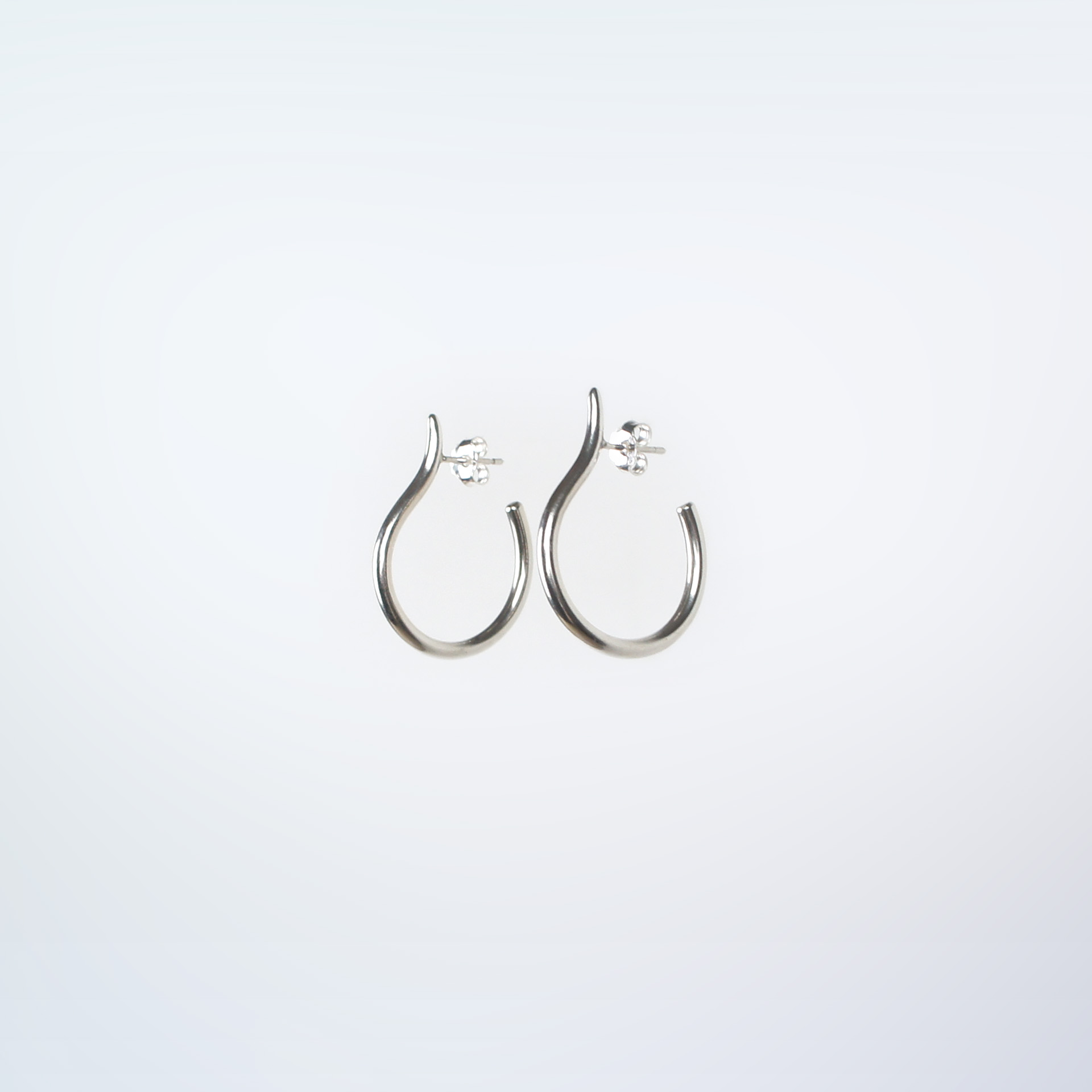 Mugura minimalist silver hoops.