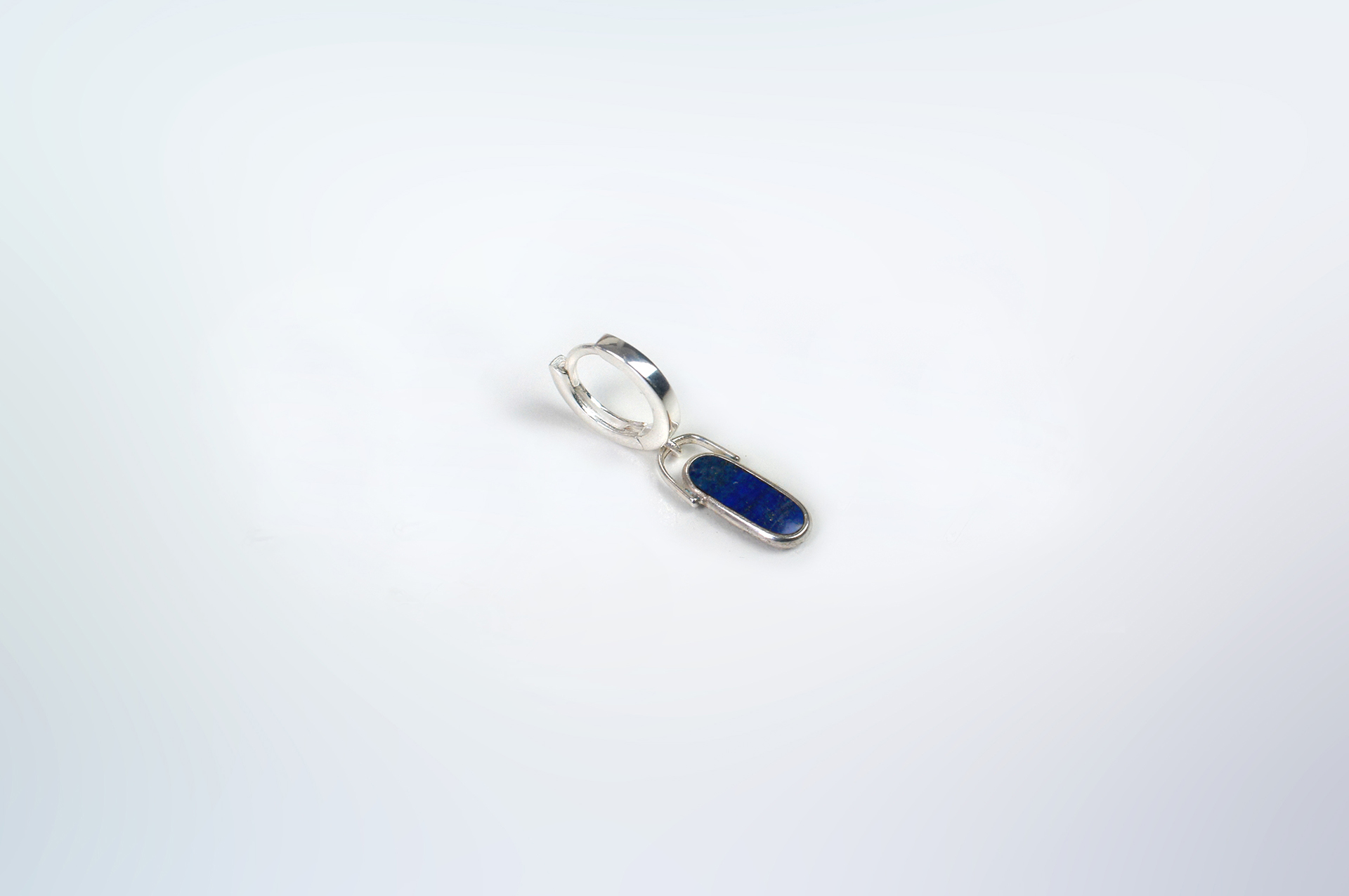 Rokku solo hoop earring in sterling silver with lapis lazuli stone.