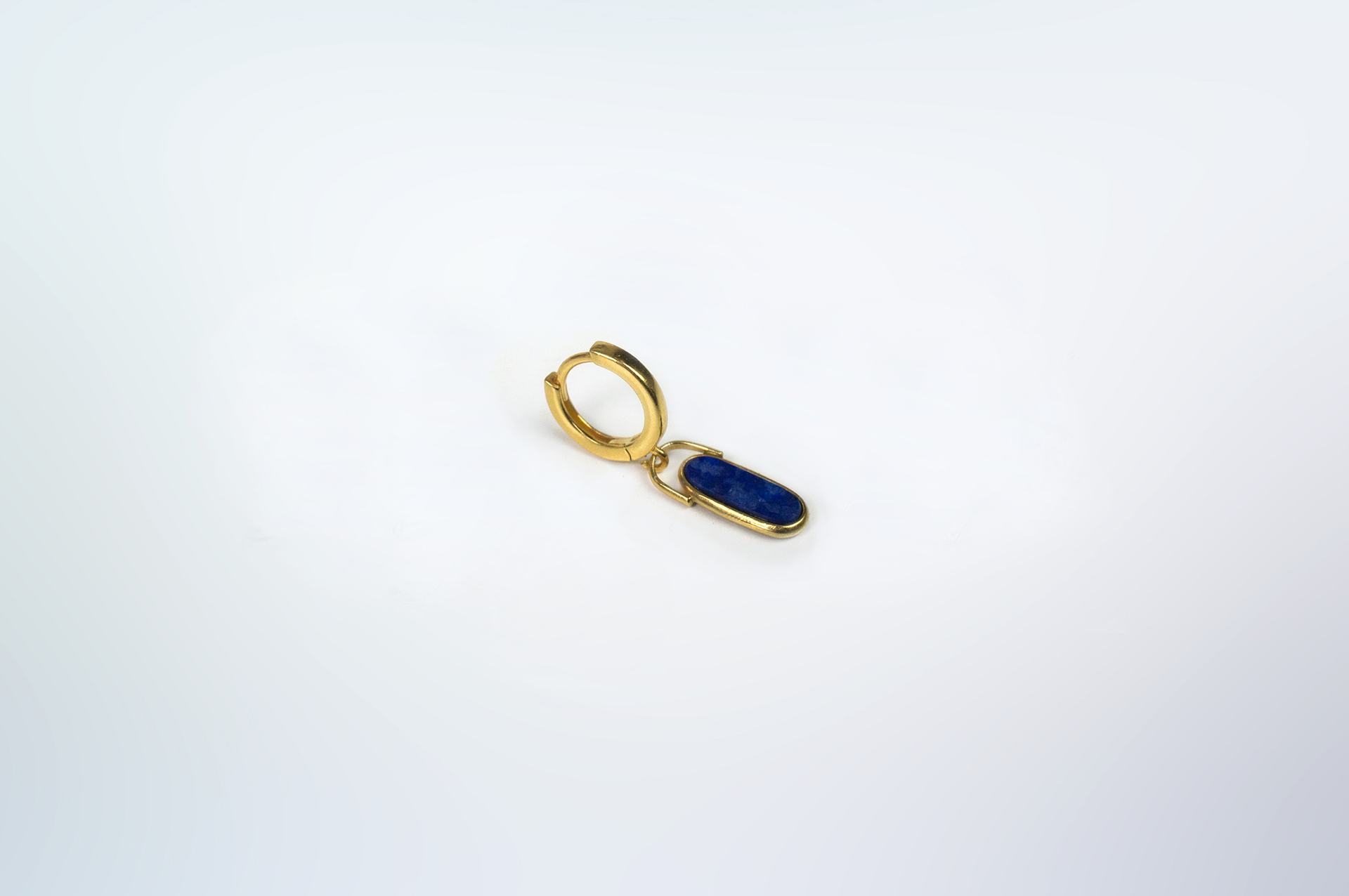 Rokku solo hoop earring in gold plated silver with lapis lazuli stone.