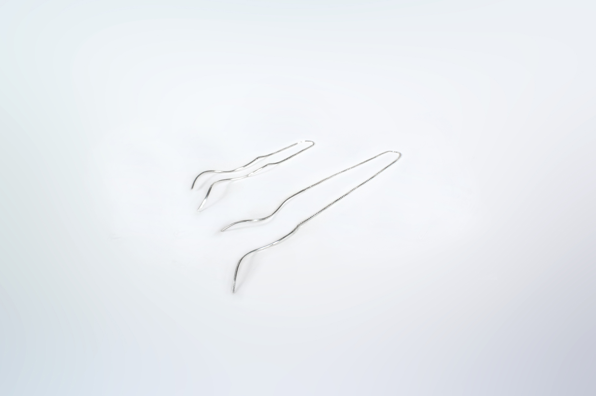 Tamanori thin dangling earrings in sterling silver.