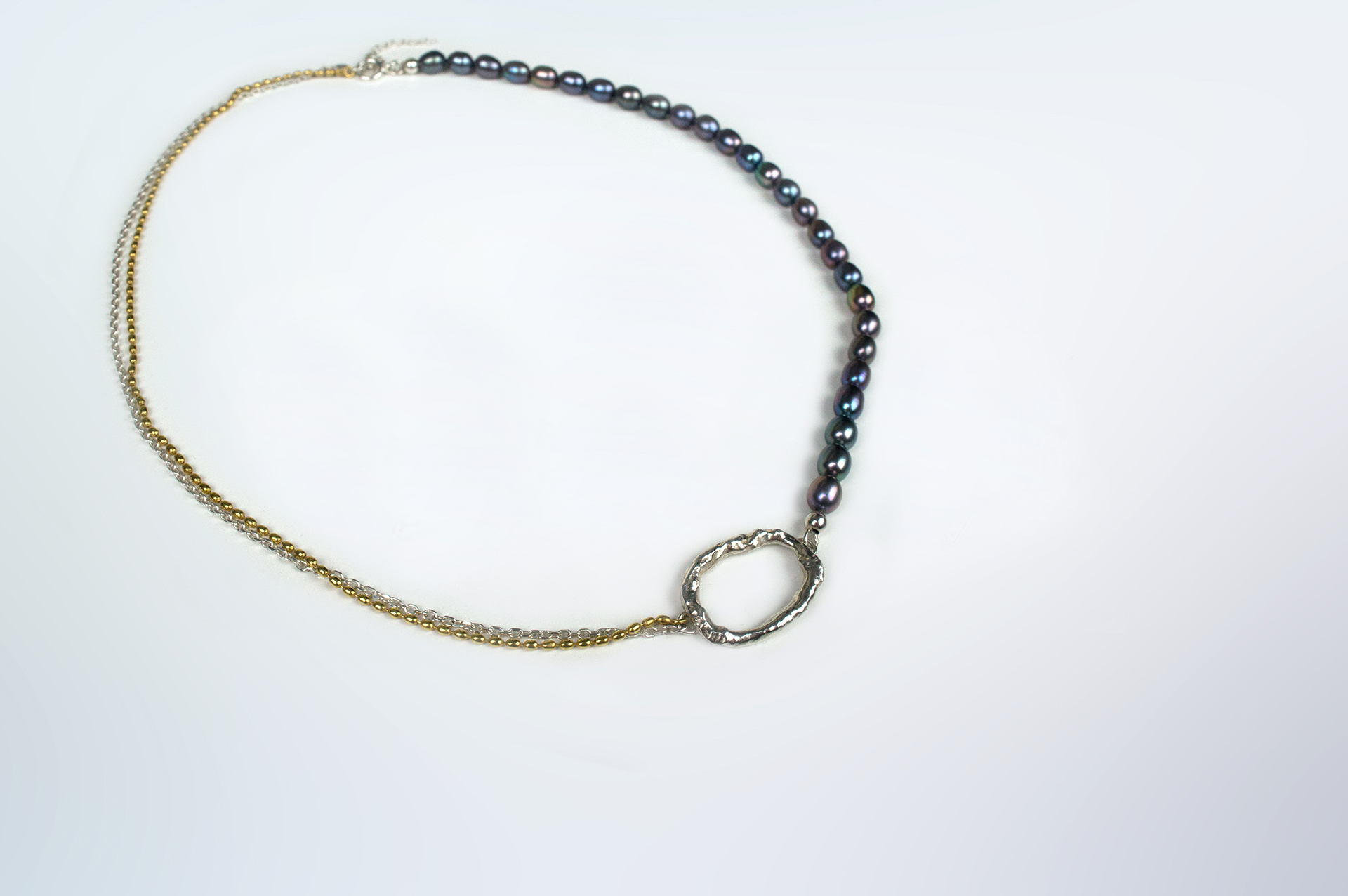 Tanemaki silver necklace with fresh water grey pearls and gold plated details.