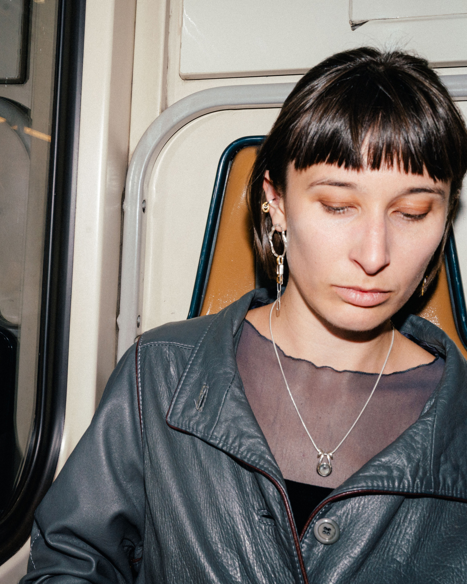 Fuyou long dangling earrings in silver with fluid oval shapes and gold plated details.