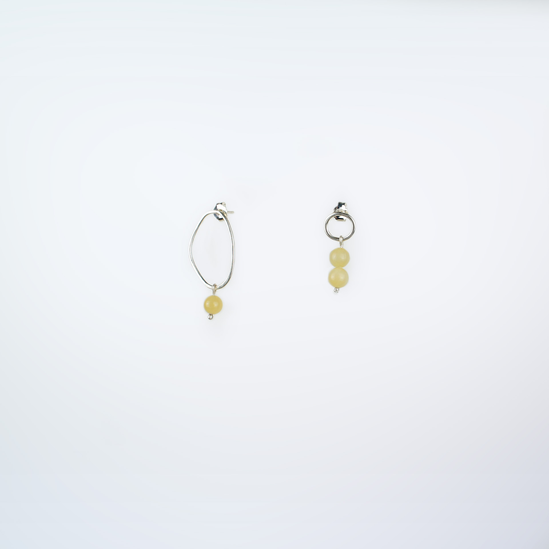 Boroboro asymmetrical silver earrings with honey calcite beads.