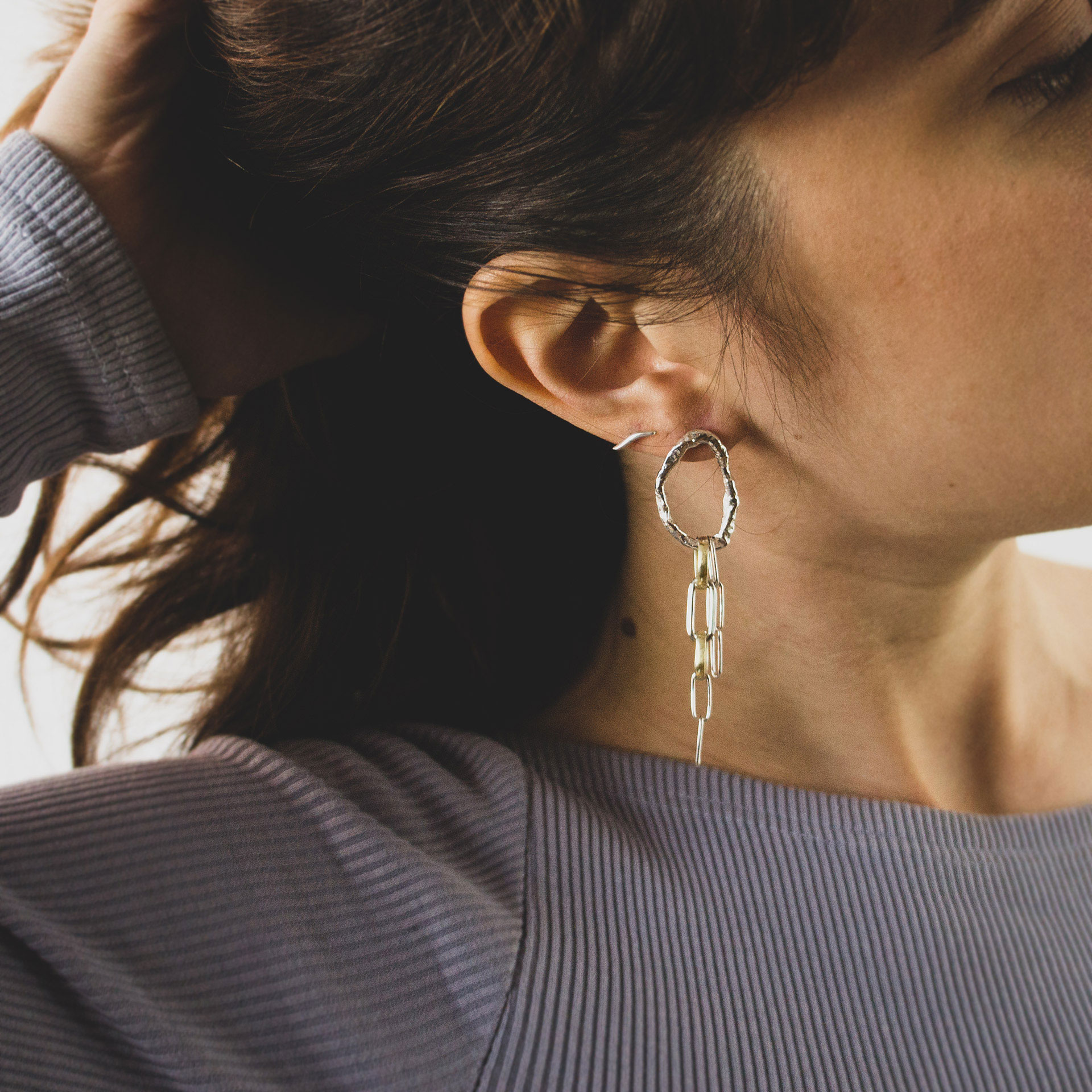 Fuyou long dangling earrings in silver with fluid oval shapes and gold plated details.
