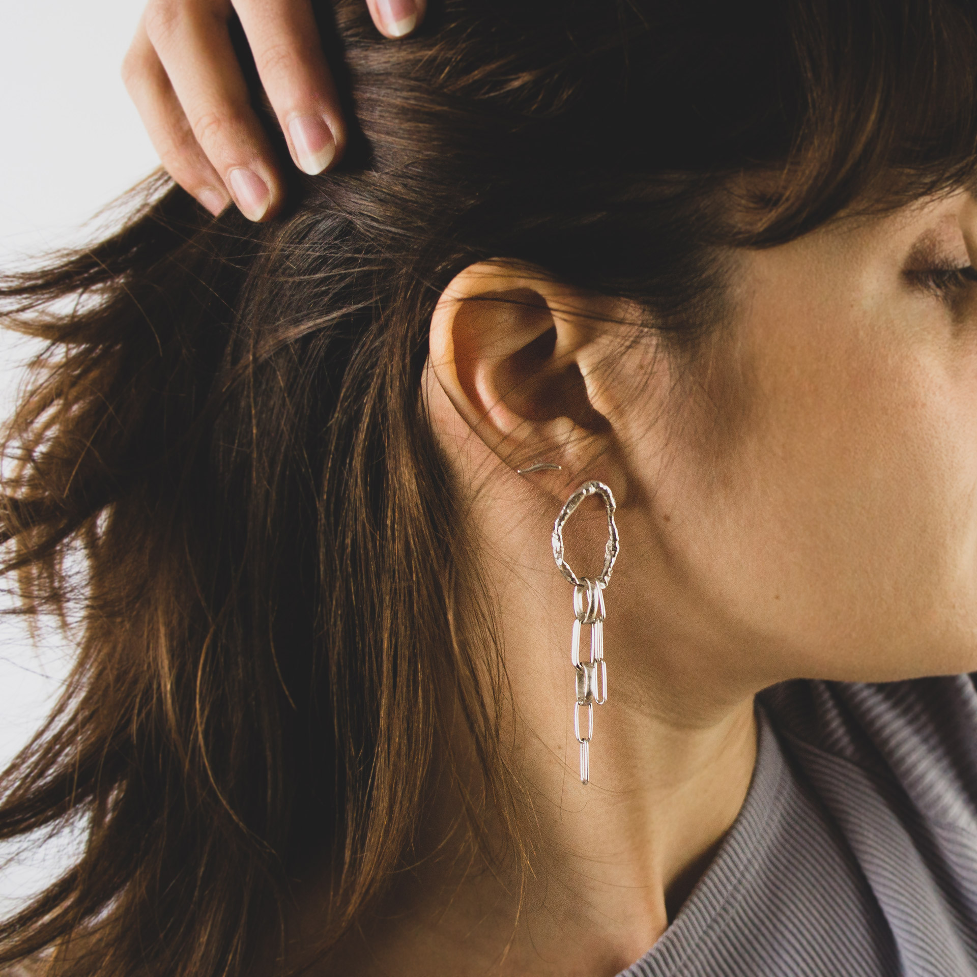 Fuyou long dangling earrings in silver with fluid oval shapes and chains.