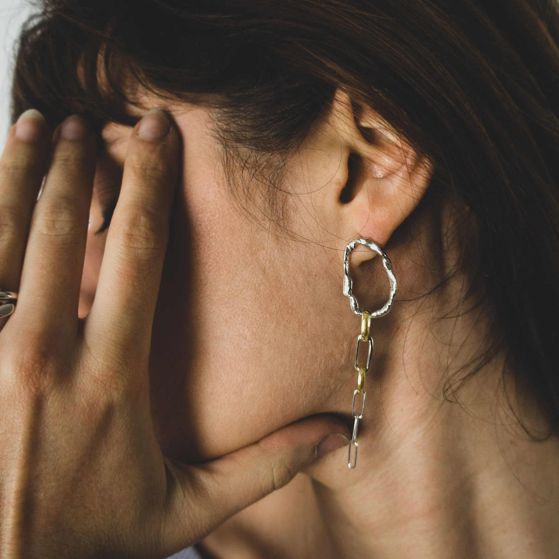 Fuyou long dangling earrings in silver with fluid oval shapes and gold plated details.