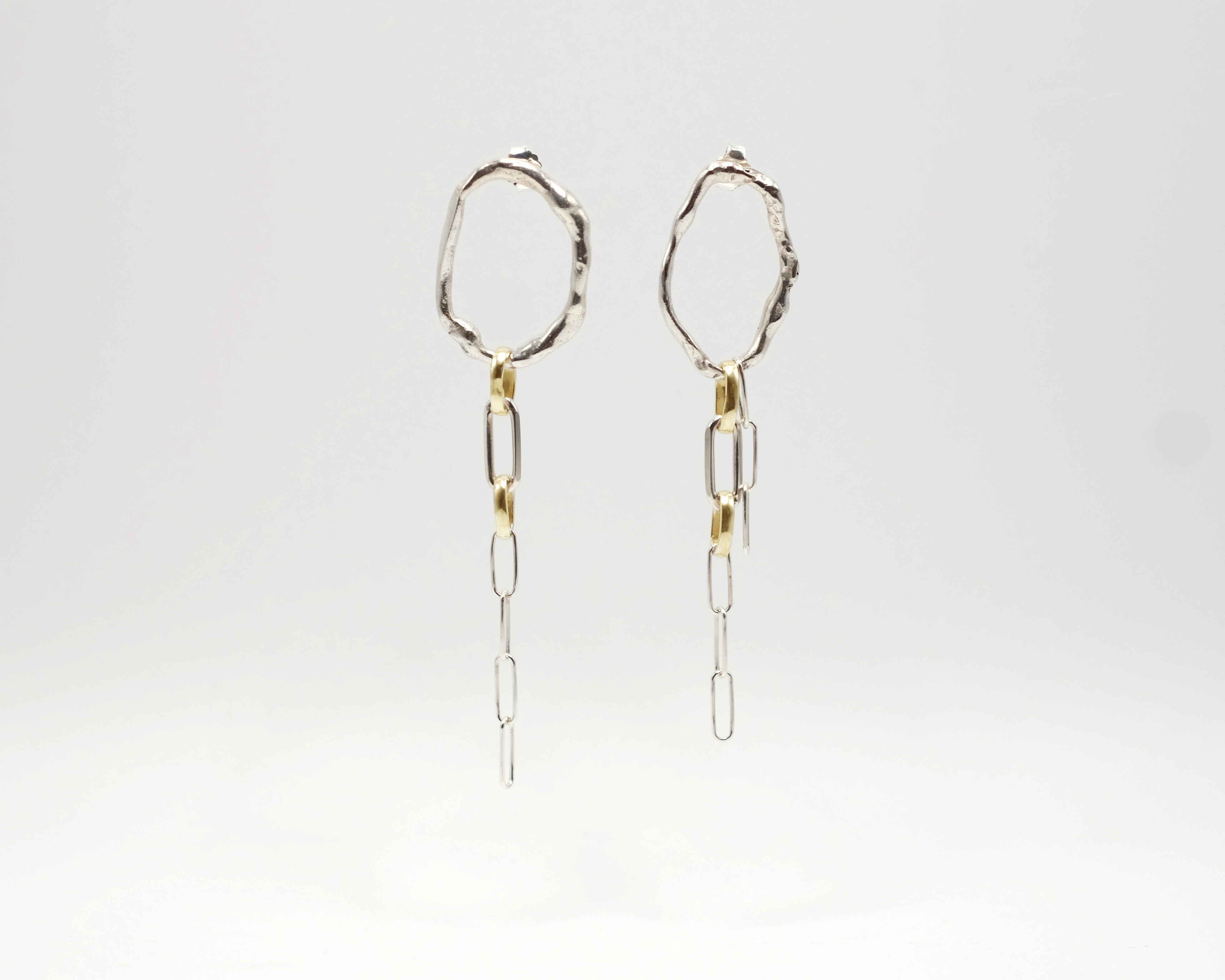 Fuyou long dangling earrings in silver with fluid oval shapes and gold plated details.