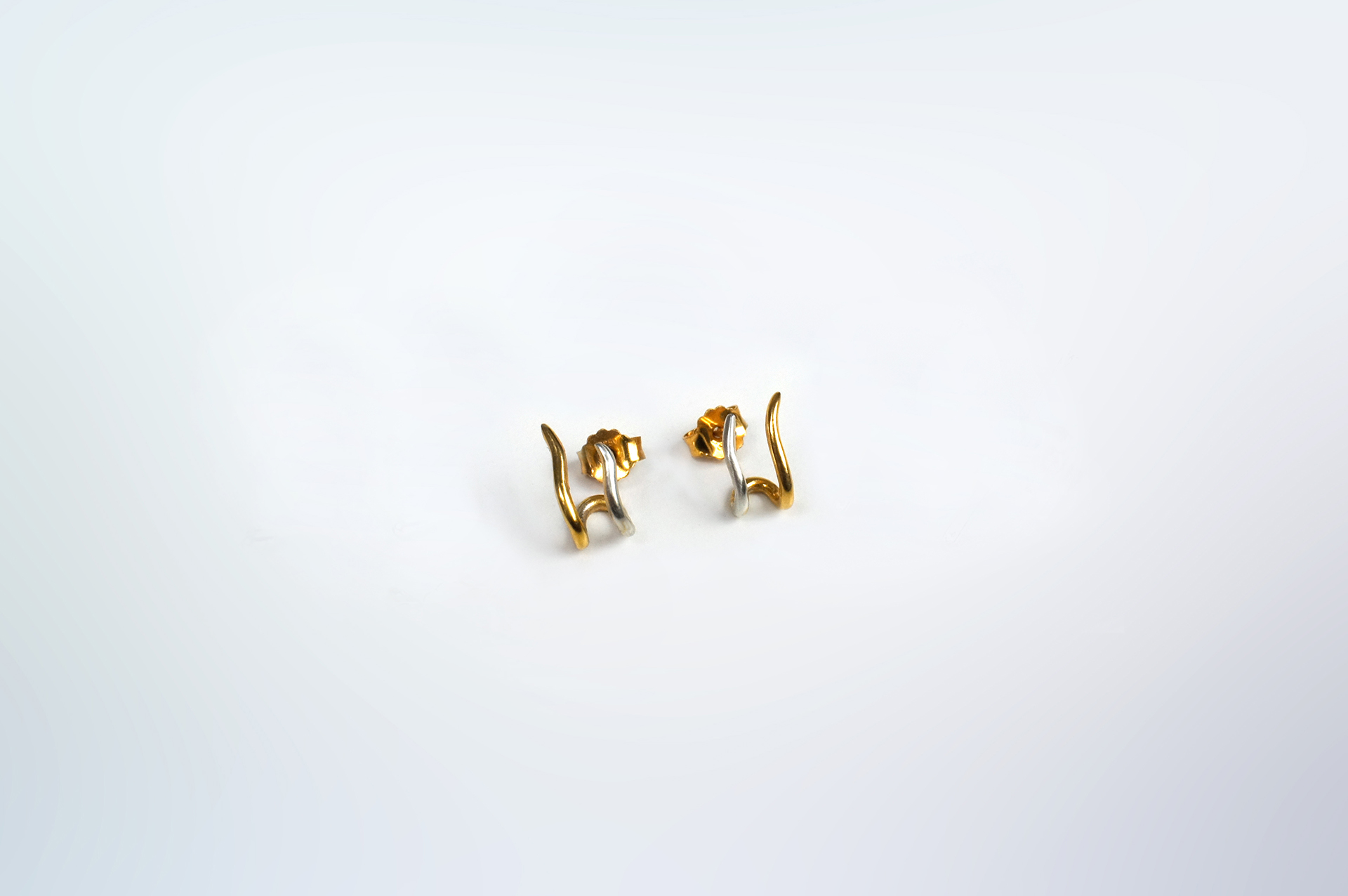 Hadou wavy stud earrings in silver.