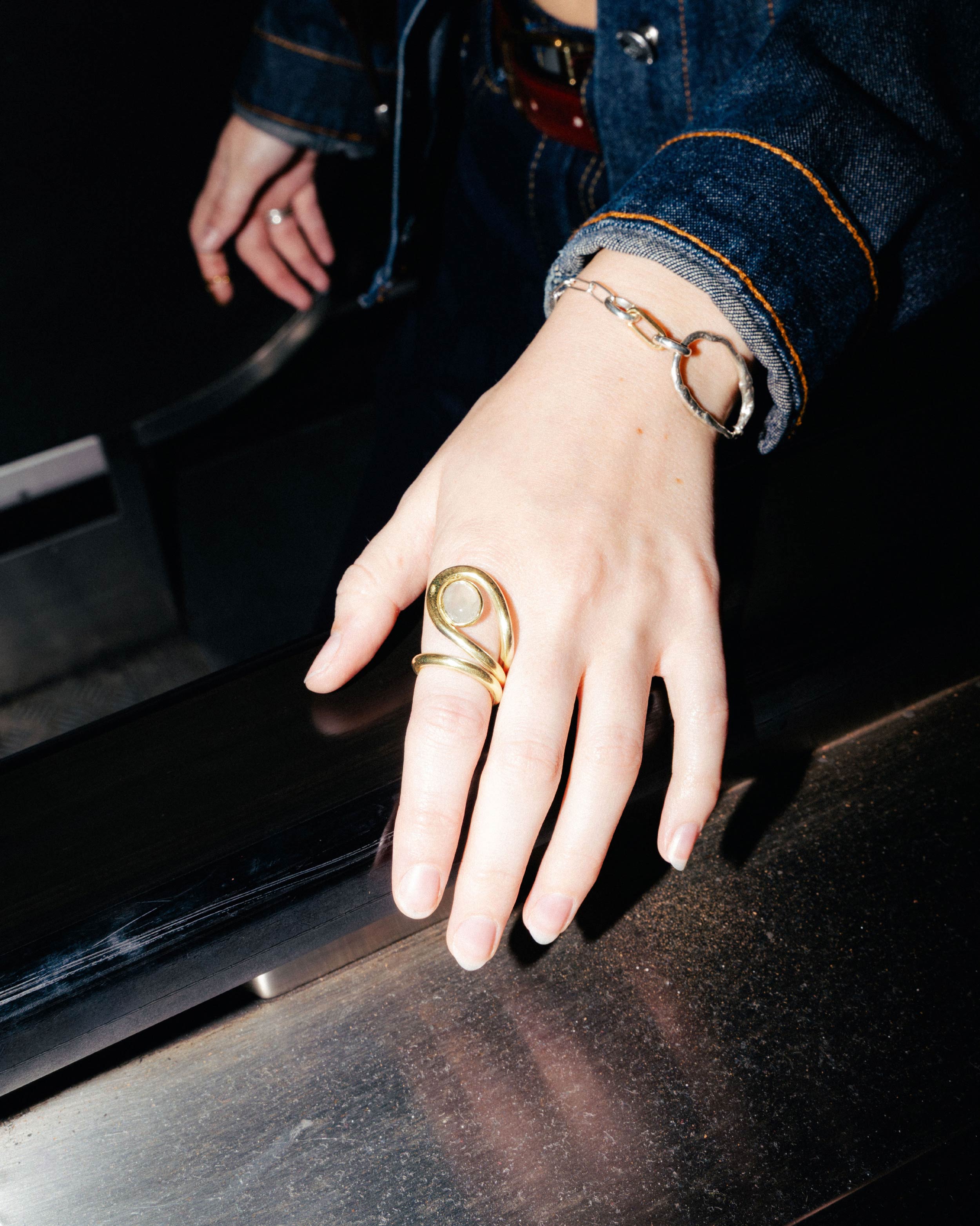 Uteki swirling ring with a prehnite oval stone. In gold plated silver.