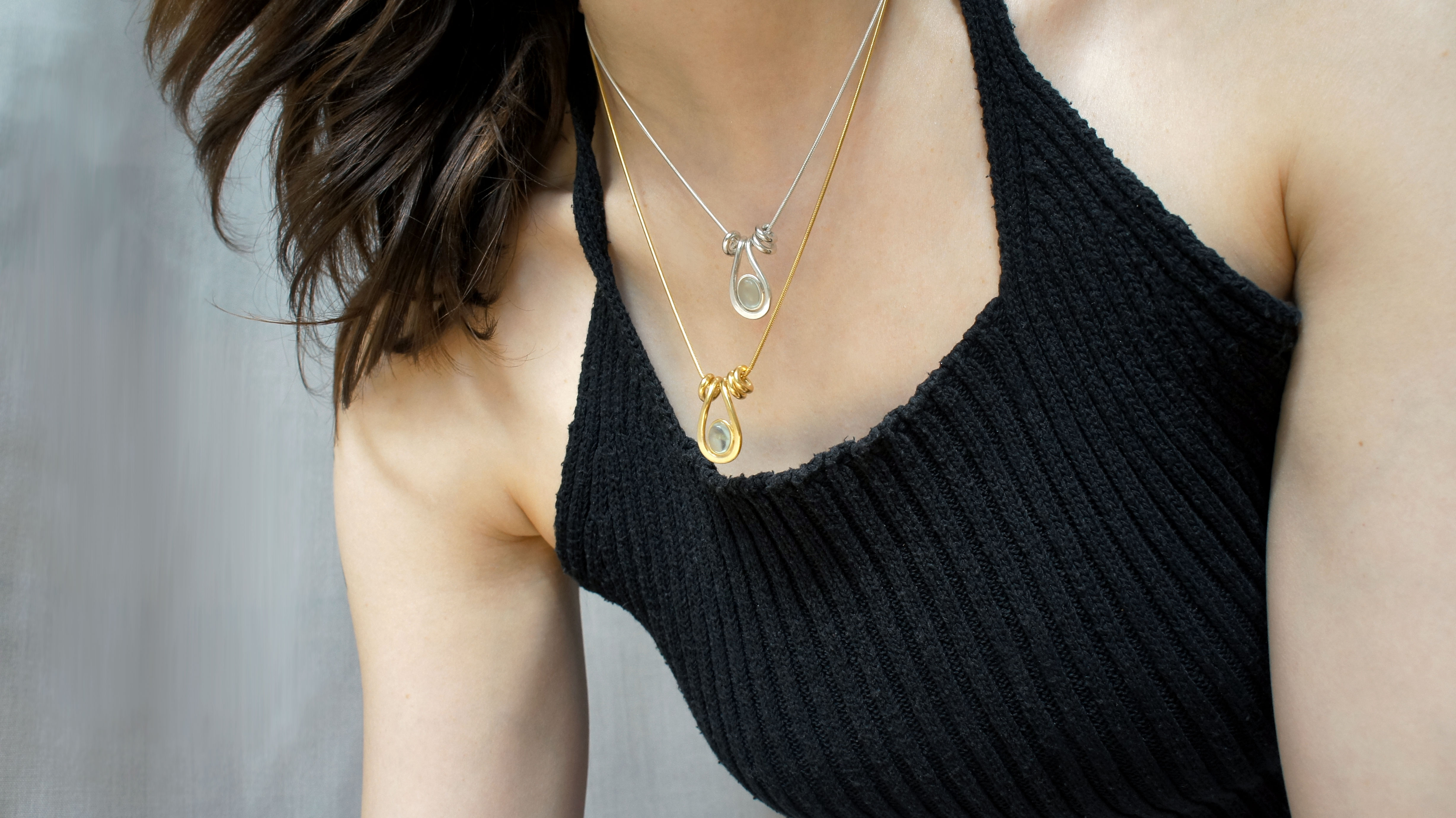Uteki necklaces with a droplet pendant and prehnite oval stone.