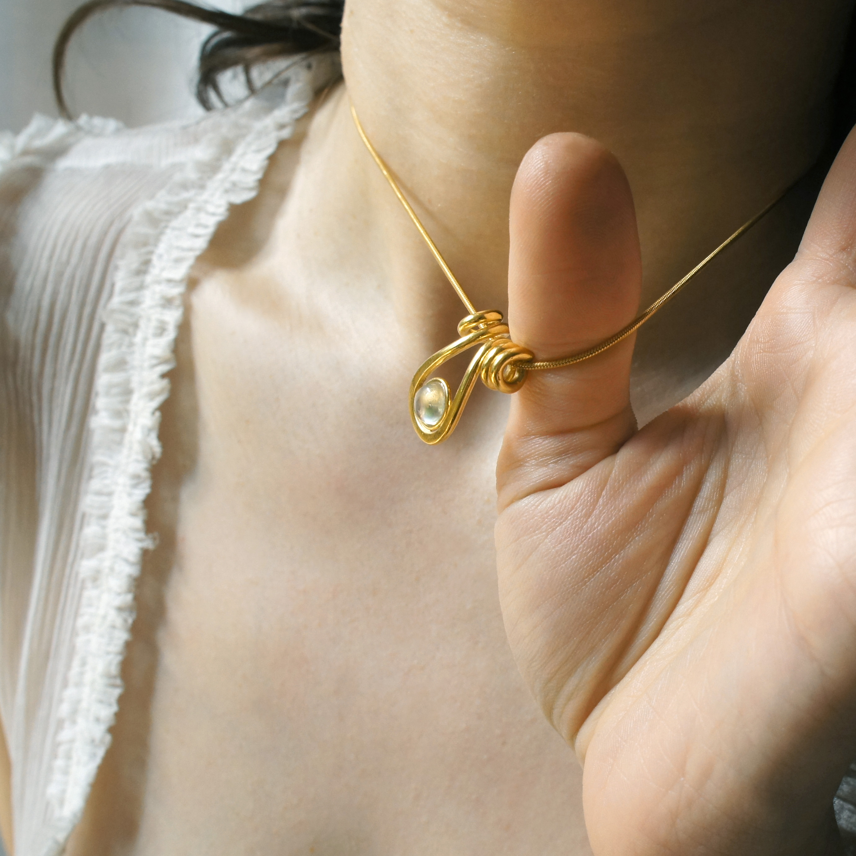 Uteki necklace with a droplet pendant and prehnite oval stone.