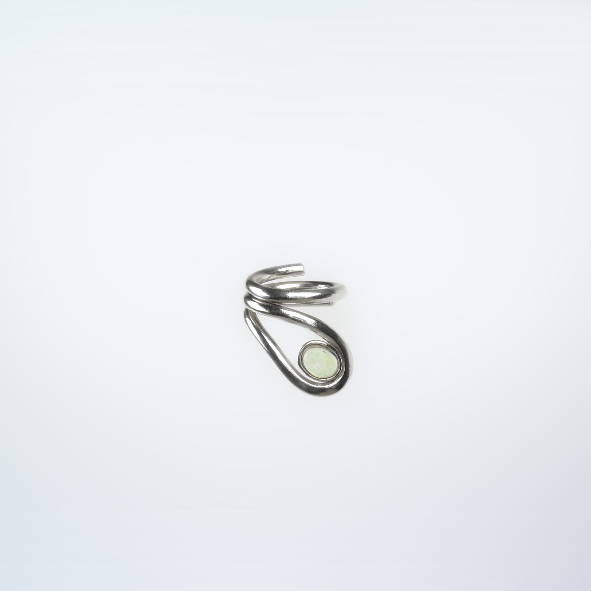 Uteki swirling ring with a prehnite oval stone. In sterling silver