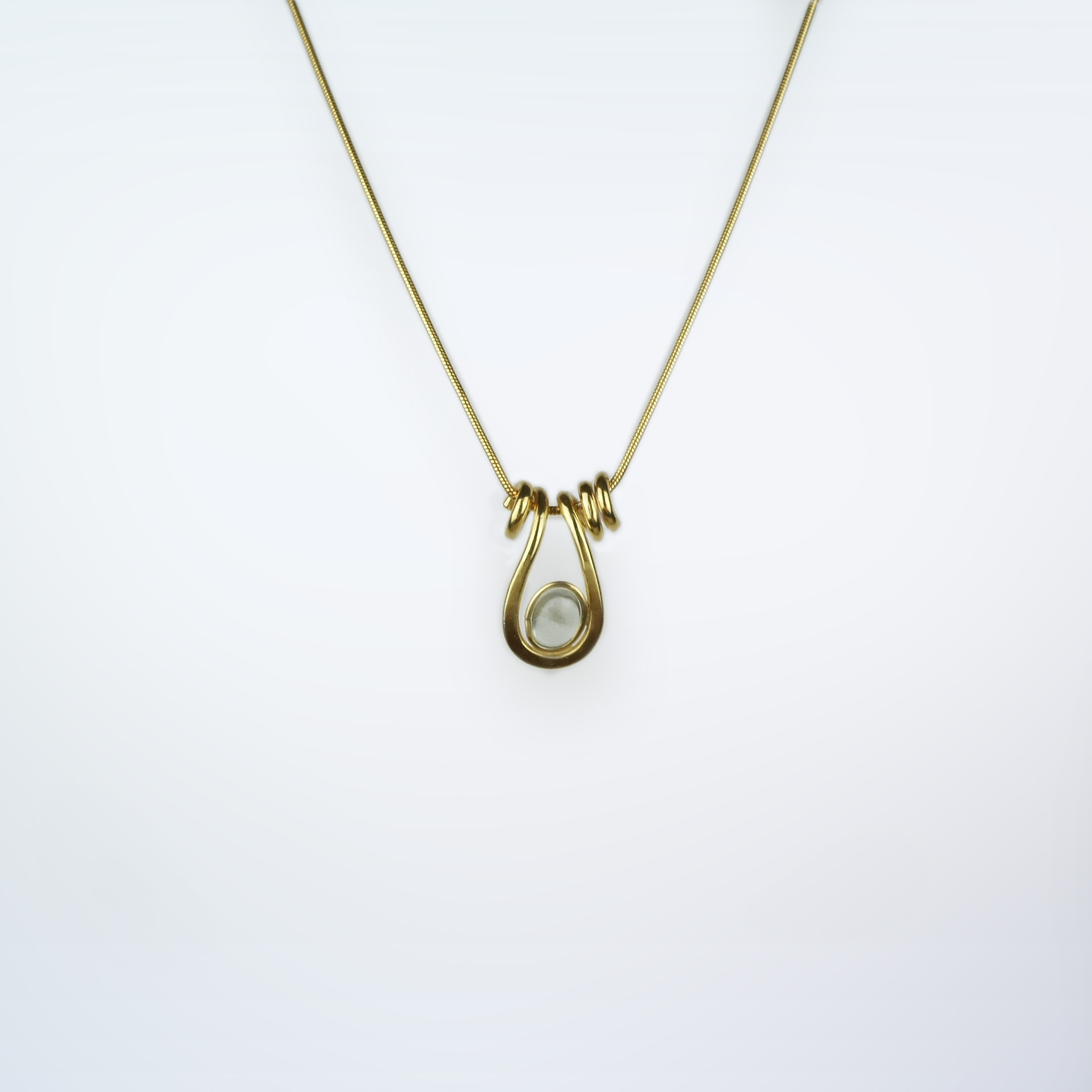 Uteki necklace with a droplet pendant and prehnite oval stone. In gold plated silver
