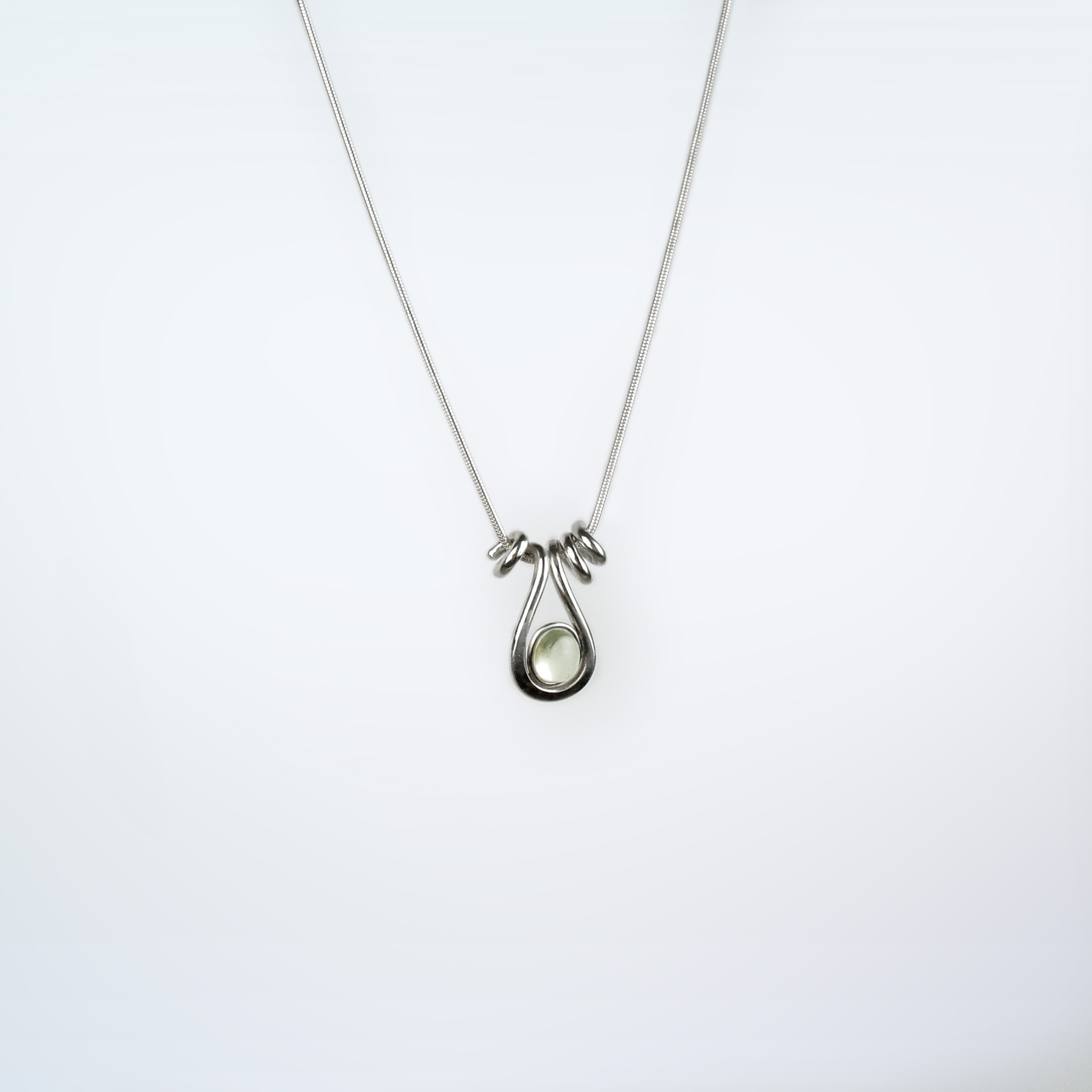Uteki necklace with a droplet pendant and prehnite oval stone. In sterling silver