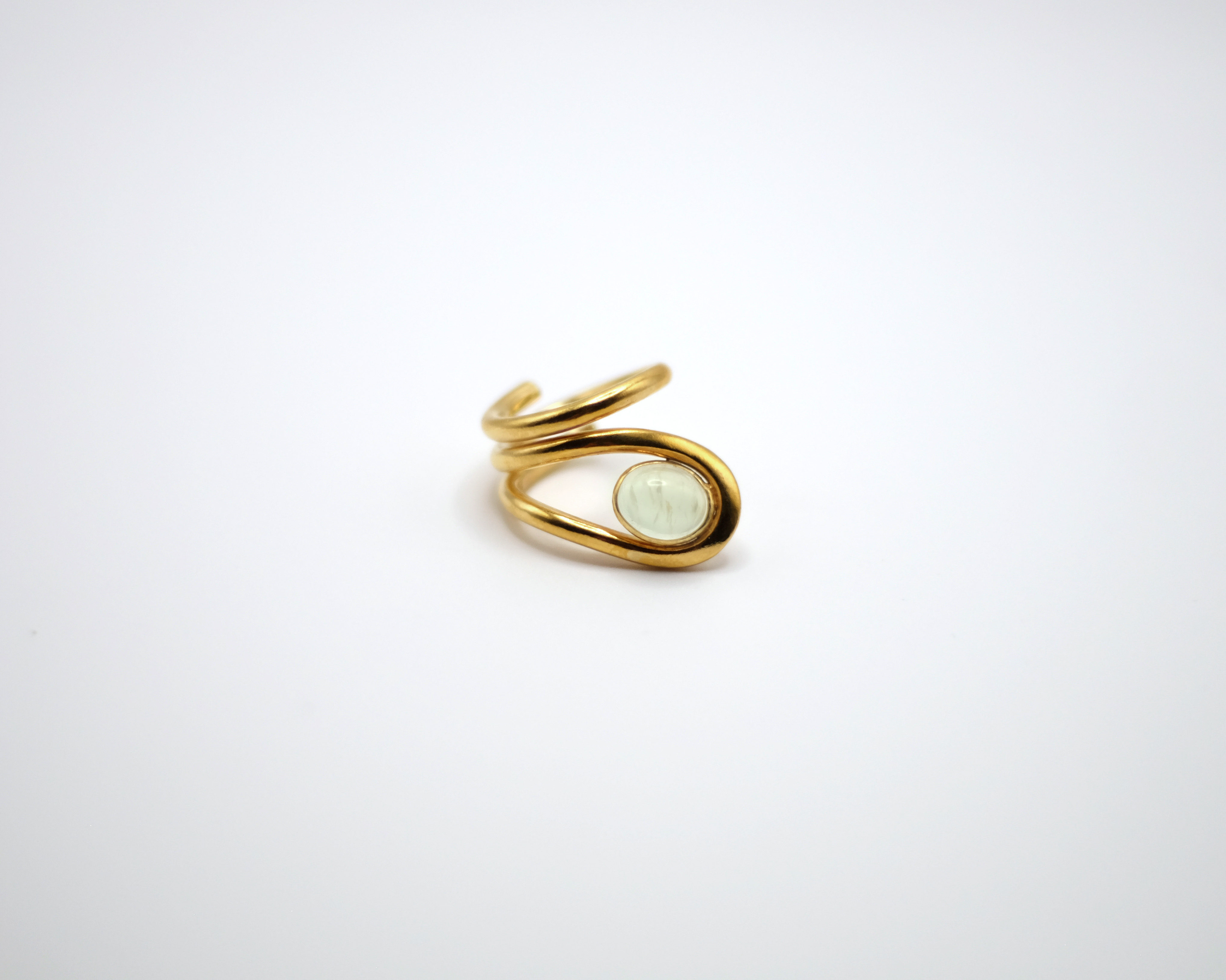 Uteki swirling ring with a prehnite oval stone. In gold plated sterling silver