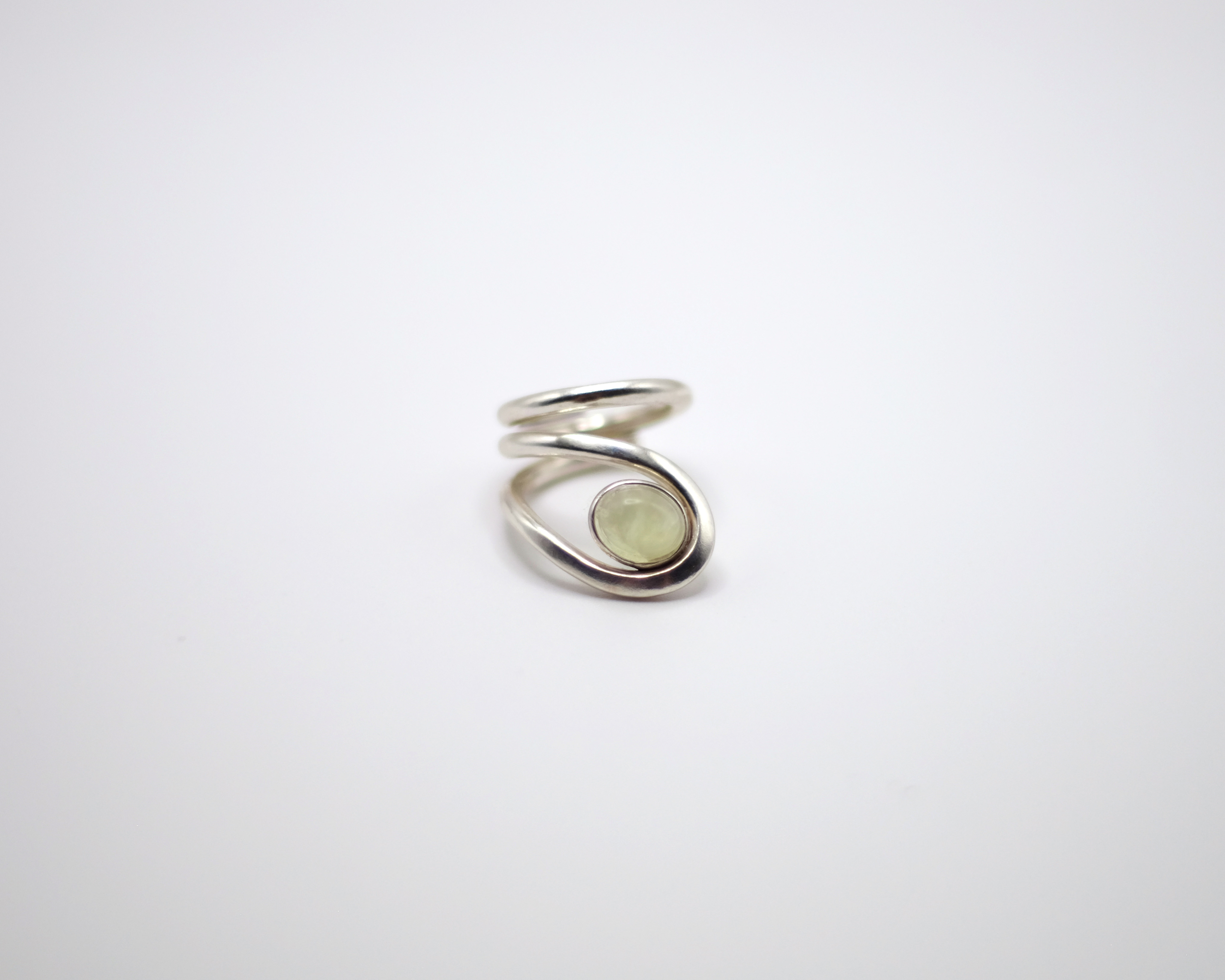 Uteki swirling ring with a prehnite oval stone. In sterling silver