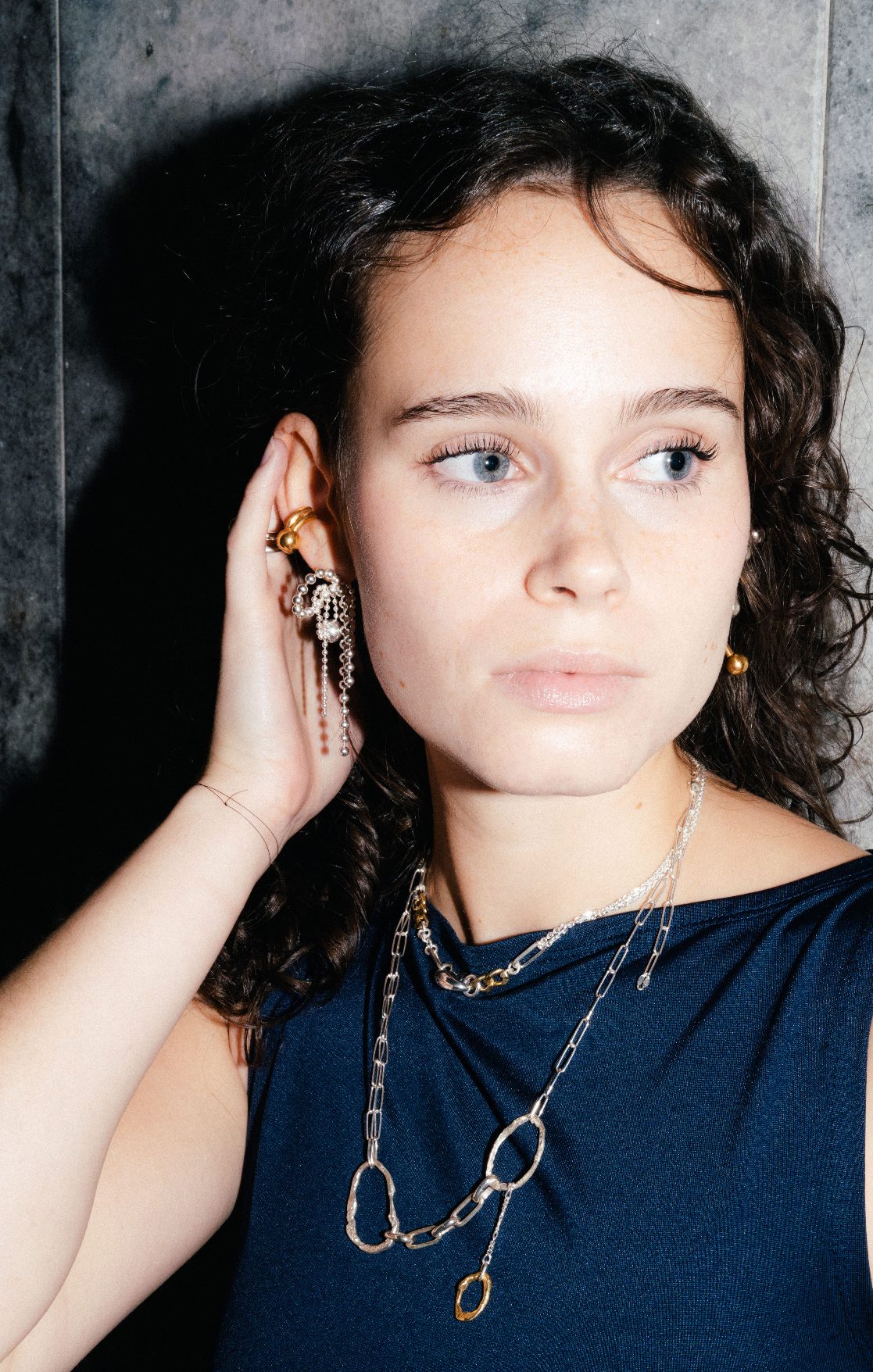 PuchiPuchi earrings made of tied ball chains forming bows in sterling silver.