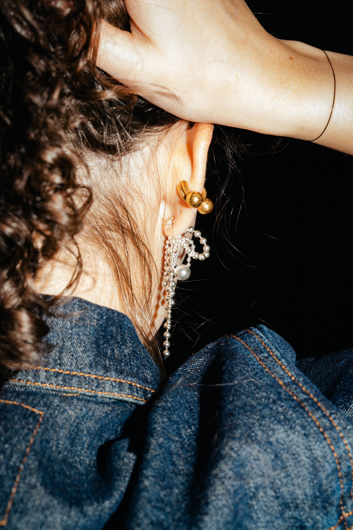 PuchiPuchi earrings made of tied ball chains forming bows in sterling silver.