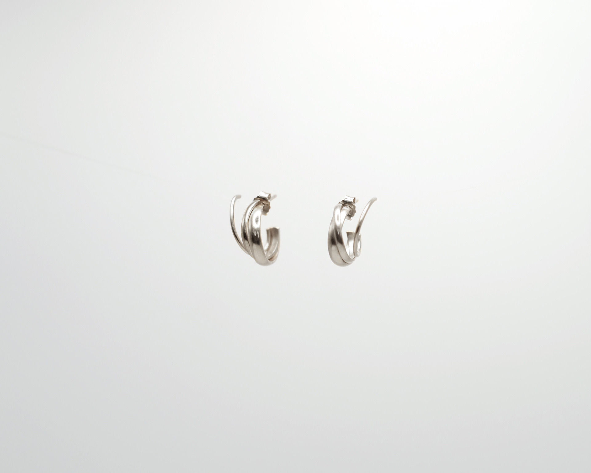 Hattari small crossed hoops in sterling silver.